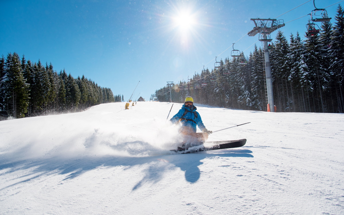skier riding at winter resort in mountains